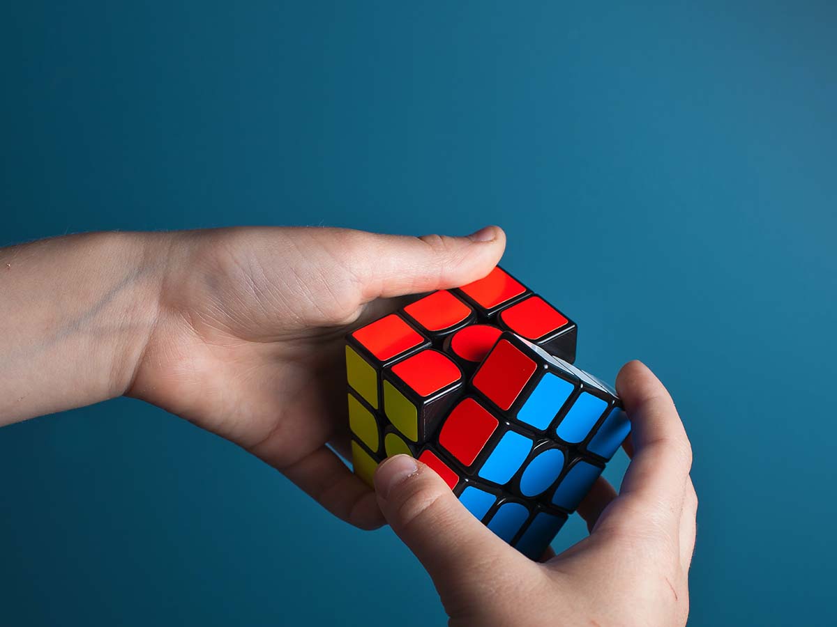 1200x900GMB-1 Person trying to solve a Rubix cube