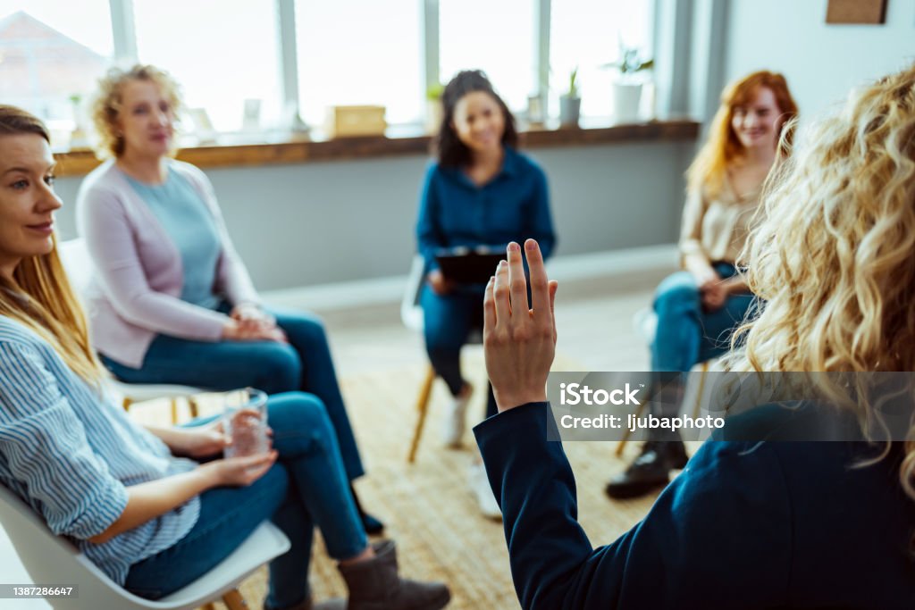 Young female HOA president leads her neighbors in a vote during an HOA meeting