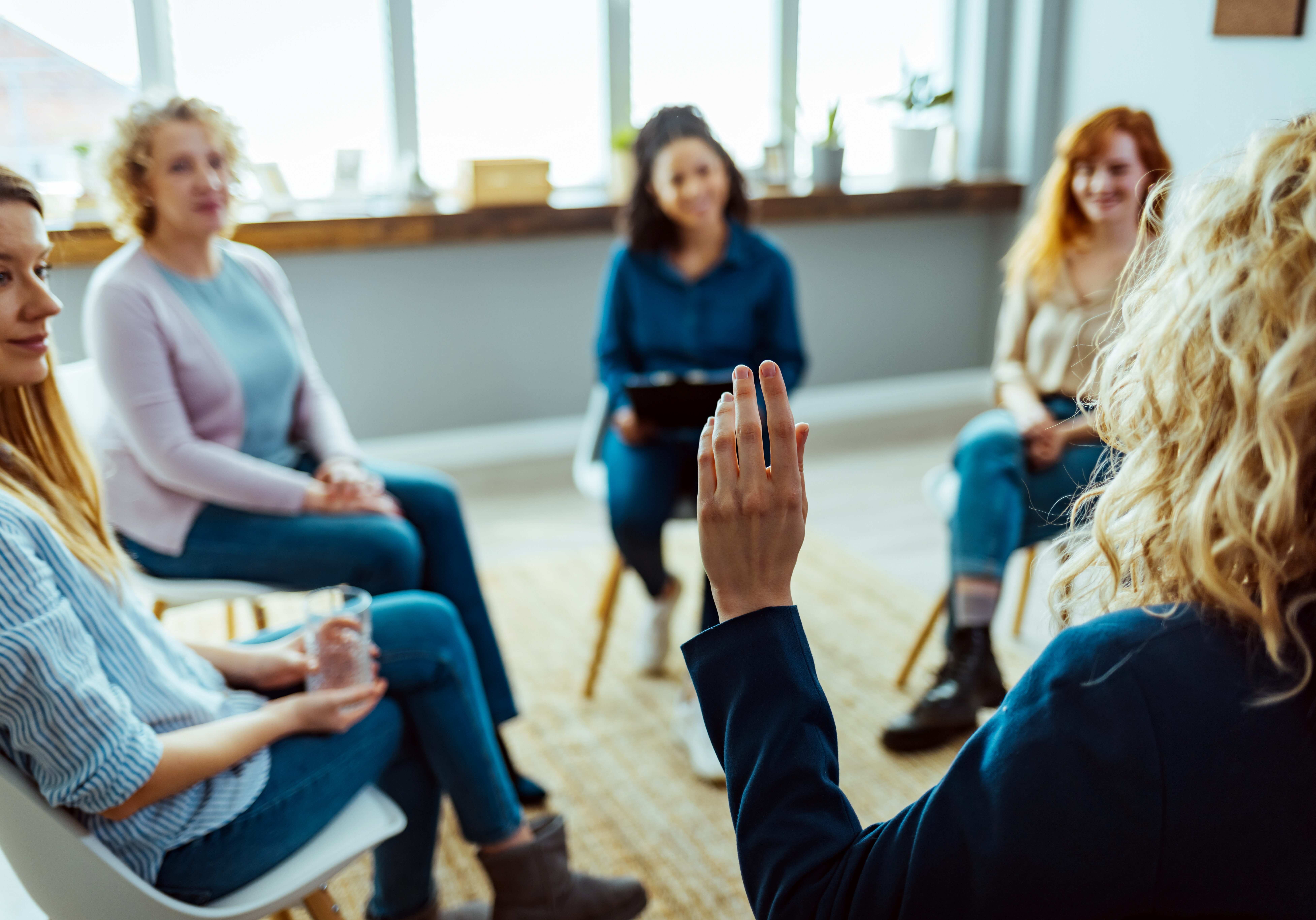 Young female HOA president leads her neighbors in a vote during an HOA meeting